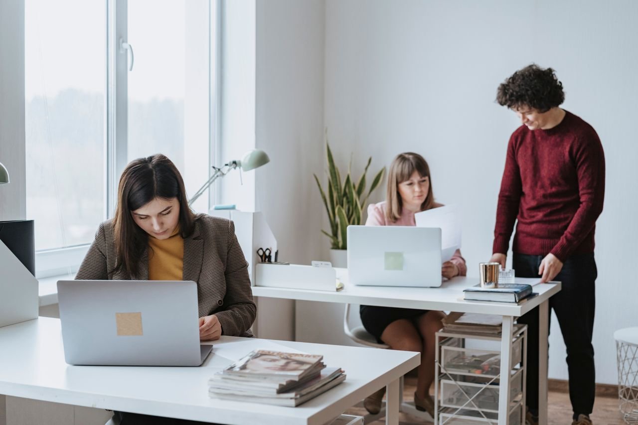 Office team reviewing documents at a shared desk