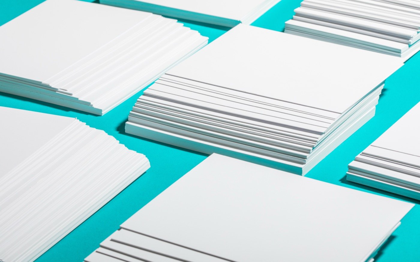Organized stacks of paper on a work table